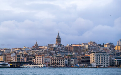 sunset view in istanbul bosphorus. Red sunset in Istanbul. Historical Galata tower and istanbul silhouette. View of the Galata Tower in Beyoglu district at sunset along the Golden Horn in Istanbul.

