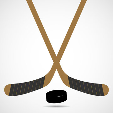 Hockey sticks and puck isolated on white background