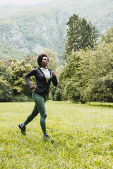 Naklejka na ściany i meble Black Woman Jogging In Nature