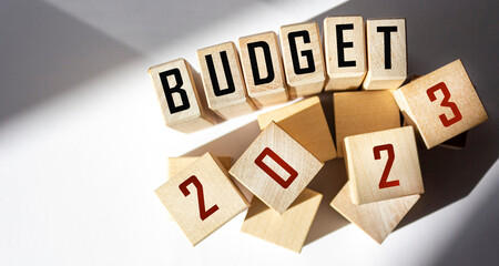 2023 budget text on wooden blocks with light background.