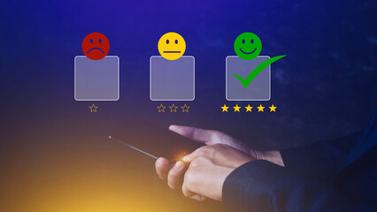 Customer service evaluation concept feedback rating and positive customer review experience, using a smartphone And pressing face emoticon smile in satisfaction on virtual touch screen