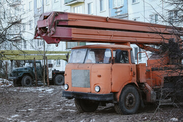 An old crane near the house is under reconstruction. Heavy machinery, construction, repair of a residential building