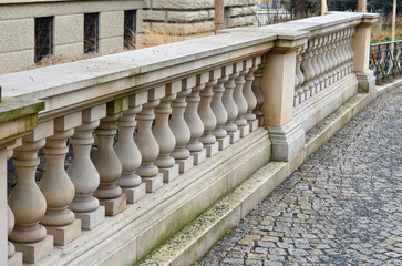 beige stone railing of a historic building balustrade reminiscent of a skittles walkway of granite cubes row, paving, balcony, terrace, house, repetition - obrazy, fototapety, plakaty