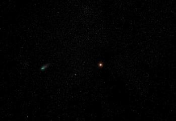 The planet Mars, and a green Comet on a starry night