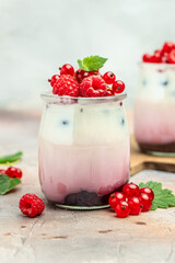 berries Yogurt. Healthy layered dessert with yogurt, jam, red currant and raspberries. Natural detox. vertical image.