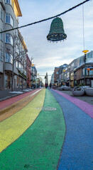 The Gay Pride rainbow from Skólavörðustígur street, one of the busiest streets leading to Hallgrimfrikja church. Once painted for Reykjavik Pride week, now permanent - obrazy, fototapety, plakaty