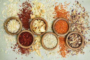Colorful mix of various dried vegetables: paprika and tomato, carrot and onion, garlic and parsnip,...