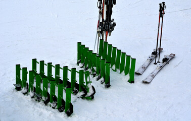 the ski center is equipped with ski racks. downhill tracks and the background of the ski resort....