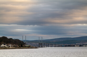 Obraz premium 12 February 2023. Kessock Bridge,Inverness,Scotland. This is the Kessock Bride over the River Ness as etc enters the sea at Inverness at sunset on a cloudy day.
