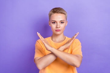 Photo of serious adorable pretty girl with short hairdo dressed yellow t-shirt hold hands crossed...