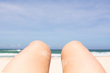Fototapeta na wymiar women's legs against the sky and sea, brazilian beach