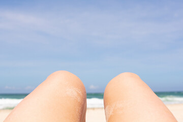 women's legs against the sky and sea, brazilian beach