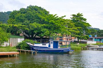 Fototapeta na wymiar FLORIANOPOLIS, BRAZIL - JANUARY 21, 2023 : boats on the Canal at Barra da Lagoa area of Lagoa da Conceicao