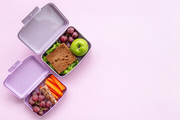 Student meal in purple lunch boxes, top view. Healthy shacks