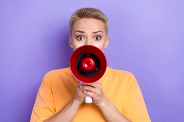 Fototapeta premium Photo of worried young girl arms hold loudspeaker talk communicate isolated on violet color background