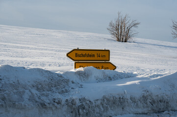 Road sign in deep snow in nature