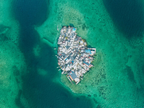 Photography from the air made on a mavic air drone on a sunny day with turquoise water. The most populated island in the world is called Santa Cruz del Islote, which is located in Colombia