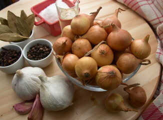 Flat lay of a table with the ingredients to prepare the snack small pickled onions