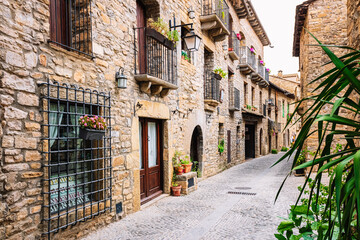 Fototapeta na wymiar Street with stone houses in the medieval village of Ainsa, Aragon, Spain