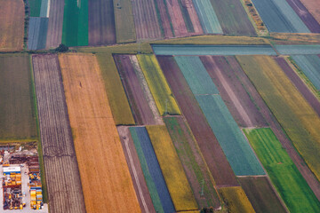 Colorful fields seen through the plane window near Warsaw airport