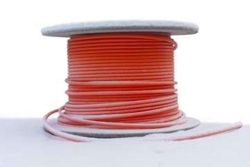 Wooden cable drum with orange cable in snow