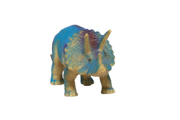 A worn toy blue triceratops dinosaur isolated on a white background. © Andres Serna