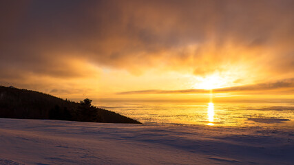 Fototapeta na wymiar Charlevoix, sunrise on the St. Lawrence coast, typical landscape of the village of Cap-à-l'aigle.