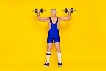 Fototapeta na wymiar Full length back rear photo of powerful sporty unknown man raise weigh challenge energy intense regime isolated on yellow color background