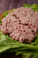 close up of beef mince on a chopping board on table 