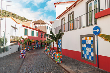 Fototapeta na wymiar Vintage street in a fishing village with banana palms on the island of Madeira