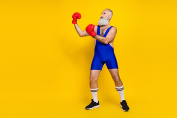 Fototapeta na wymiar Full size photo of serious concentrated sportive man arm fight empty space isolated on yellow color background