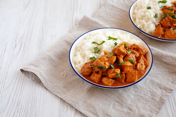 Homemade Easy Indian Butter Chicken with Rice on a Plate, side view. Space for text.