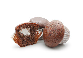 Two chocolate muffins and half with cream filling isolated on white background    