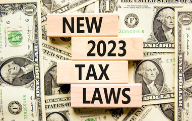 New 2023 tax laws symbol. Concept words New 2023 tax laws on wooden blocks. Dollar bills. Beautiful background from dollar bills. Business new 2023 tax laws concept. Copy space.