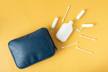 cosmetic bag for travel on a yellow background, feminine hygiene products