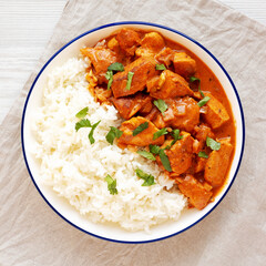 Homemade Easy Indian Butter Chicken with Rice on a Plate, top view. Flat lay, overhead, from above.