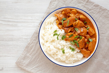 Homemade Easy Indian Butter Chicken with Rice on a Plate, top view. Flat lay, overhead, from above. Copy space.