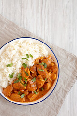 Homemade Easy Indian Butter Chicken with Rice on a Plate, top view. Flat lay, overhead, from above. Copy space.
