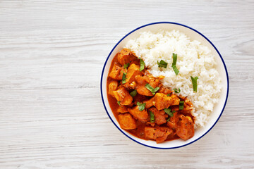 Homemade Easy Indian Butter Chicken with Rice on a Plate, top view. Flat lay, overhead, from above. Space for text.