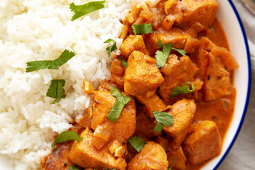 Homemade Easy Indian Butter Chicken with Rice on a Plate, top view. Flat lay, overhead, from above. Close-up.