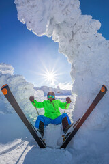Skier is having fun during beautiful winter scenery in high mountains against sunset. - 571372780
