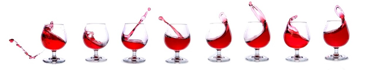 Glasses with splash of red wine isolated on white background