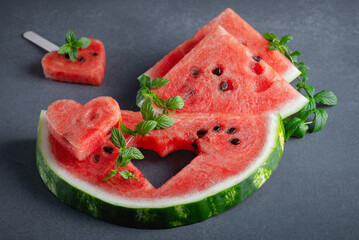 Slices of watermelons on grey table. Copy space