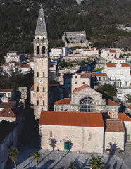 Fototapeta na wymiar Perast, Montenegro, beautiful aerial top panoramic view of Perast old town with st. Nikola church, with Adriatic sea, bay of Kotor, Dinaric Alps mountains in sunny day