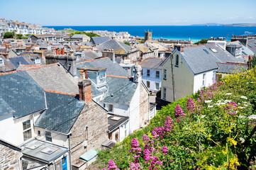 View of rooftops in St Ives, west Cornwall, South West England. Beautiful blue sea on the background. Selective focus