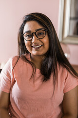 Head shot portrait smart confident smiling millennial indian woman. Attractive young hindu teenager student girl freelancer looking at camera, posing for photo.