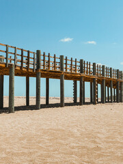 Large wooden bridge background with a field of sand in the beach from puerto rico isabela west side