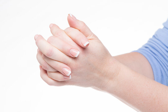 woman has hands clasped in prayer isolated against white background