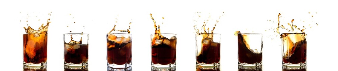 Many glasses of cola with splash and ice cubes on white.