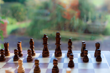 Wooden chess pieces on a wooden playboard